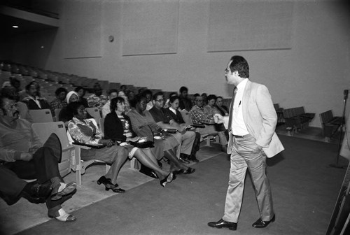 Community Youth Gang Services meeting attendees listening to a speaker, Los Angeles, 1982