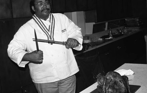 Chef preparing a turkey at a "Holiday Cooking Secrets" event, Los Angeles, 1986