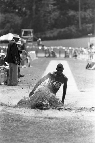 Carl Lewis completing a long jump, Los Angeles, 1982