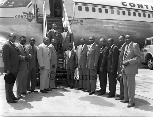 Group of men at airport, Los Angels, 1962