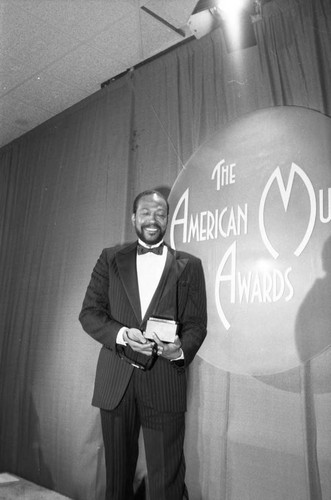 Marvin Gaye posing with his American Music Award, Los Angeles, 1983