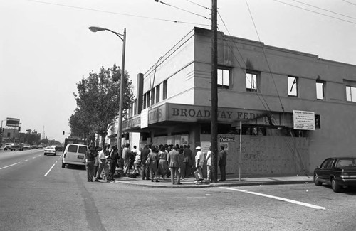 Crowd gathering at the destroyed Broadway Federal Savings and Loan building, Los Angeles, 1992