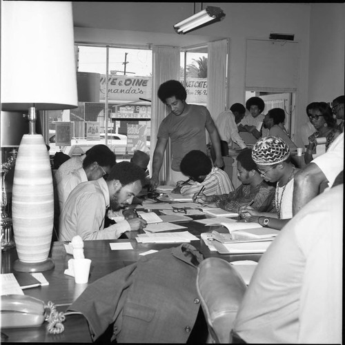 Ken Orduna overseeing the work of deputy voting registrars in training, Los Angeles, 1972