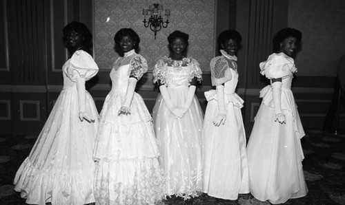 Debutantes posing together in a ballroom, Los Angeles, 1984