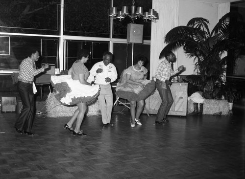 Guests dancing together at the National Association of Media Women's western hoedown, Los Angeles, 1983