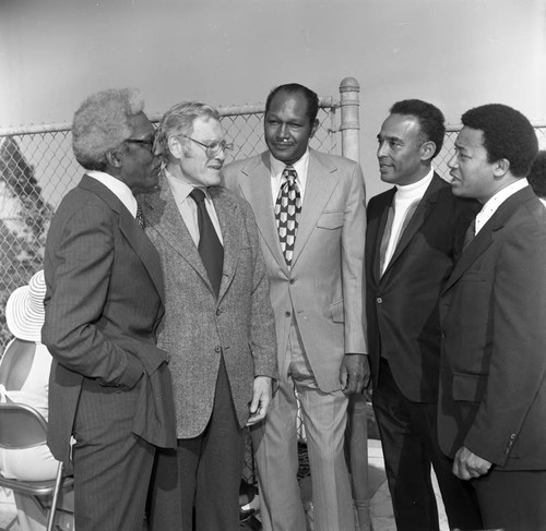 Bayard Rustin and others talking together at an event in his honor, Los Angeles, 1973