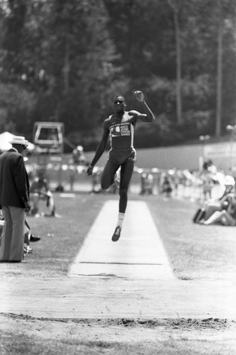 Carl Lewis completing a long jump, Los Angeles, 1982