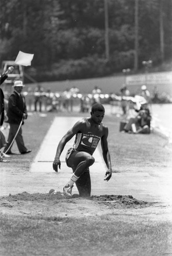 Carl Lewis completing a long jump, Los Angeles, 1982