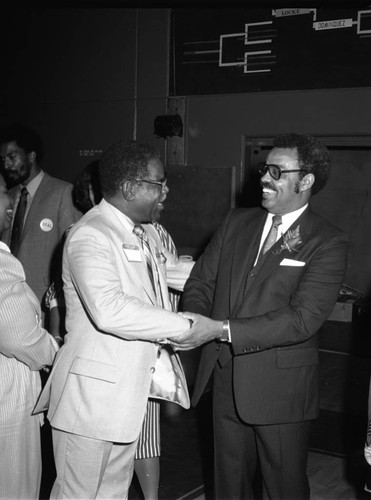 Dr. Rex Fortune greeting attendees at a special event, Inglewood, California, 1983