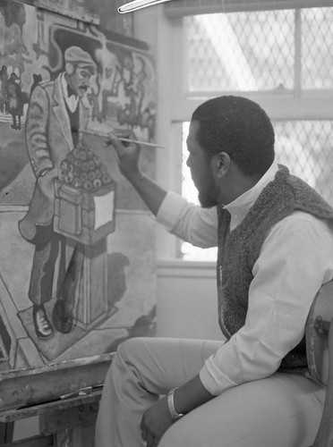 Ernest Johnson applying his paint brush to a canvas, Los Angeles, 1983