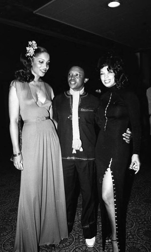 Hugh Masekela talking with production hostesses during the NAACP Image Awards, Los Angeles, 1978