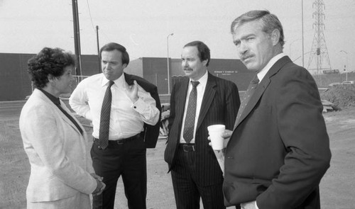 Real estate developers standing on-site discussing a project, Los Angeles, 1982