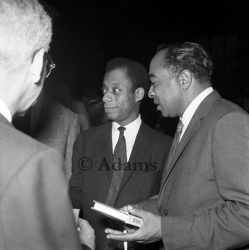 James Baldwin talking with others at a cocktail party, Los Angeles, 1964