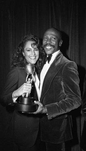 Jayne Kennedy and Louis Gossett Jr. posing with an NAACP Image Award, Los Angeles, 1982