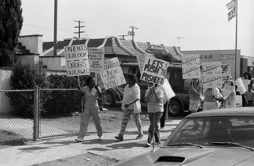 Anti-drug protestors walking down the city street, Los Angeles, 1986