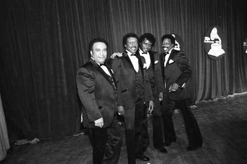 Members of The Spinners posing together at 25th Annual Grammy Awards, Los Angeles, 1983