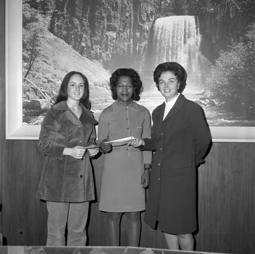 Women posing with envelopes during an event at Compton College, Los Angeles, ca. 1972