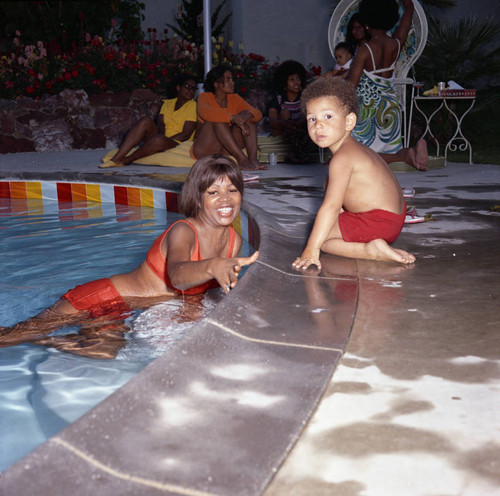 Gwen Gordy Fuqua and a young boy at Berry Gordy's house party, Los Angeles