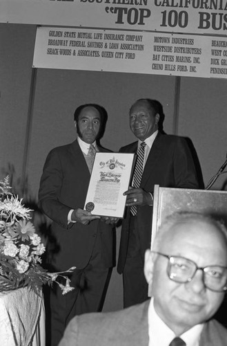 Black Enterprise Magazine's Earl G. Graves receiving a proclamation from Tom Bradley, Los Angeles, 1987