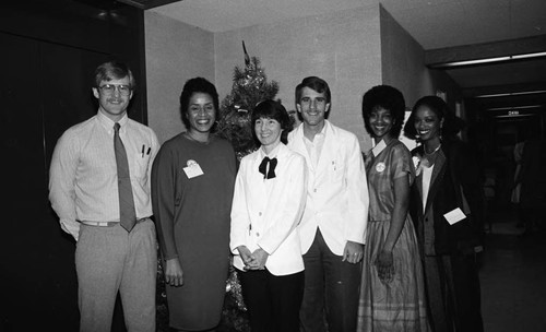 Dotson Medical Corporation staff posing together during a health care screening event, Los Angeles, 1984