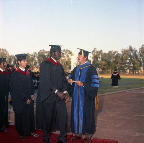 Compton College graduates participating in commencement ceremonies, Compton, 1972