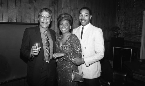 Nancy Wilson posing with others at her party, Los Angeles, 1987