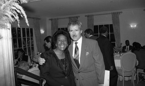 Alex Trebek posing with a supporter of the "Lou Rawls Parade of Stars" telethon, Beverly Hills, 1990