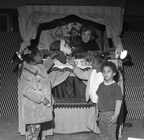 Children posing with a puppets and a puppeteer, Compton, 1972