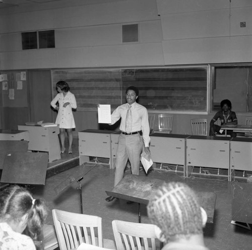 Man standing in front of a class at Compton College, Los Angeles, ca. 1972