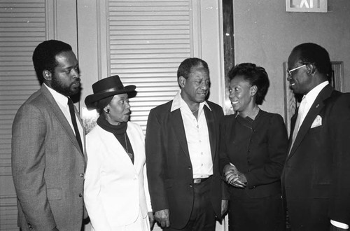 Maxine Waters talking with others at the 5th annual California Black Health Network conference, Los Angeles, 1984