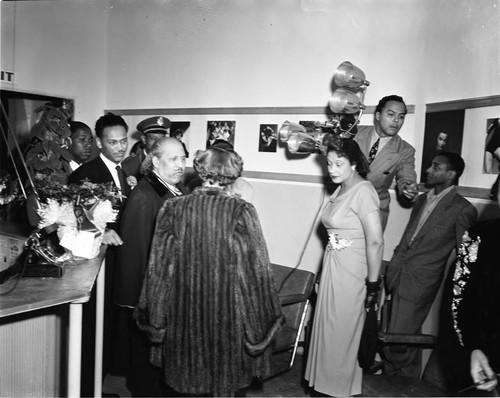 Bishop Charles Manuel "Sweet Daddy" Grace talking with others at the California School of Photography, Los Angeles, 1950