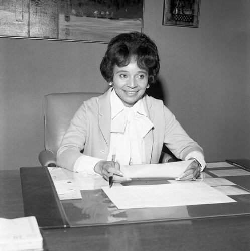 Lorraine N. Howard siting at her desk at Broadway Federal Savings and Loan, Los Angeles, 1974