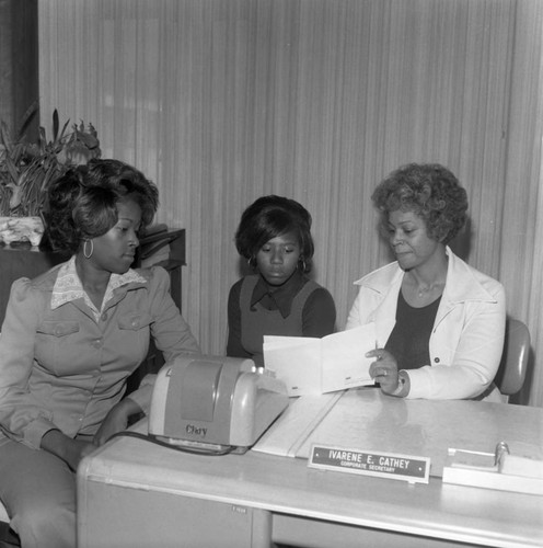 Ivarene E. Cathey examining a document at Broadway Federal Savings and Loan, Los Angeles