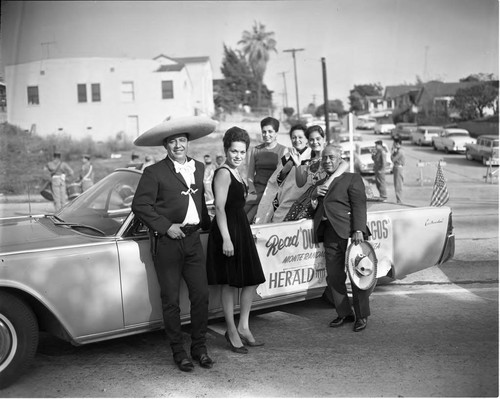 Lindsay with group in car, Los Angeles, 1963