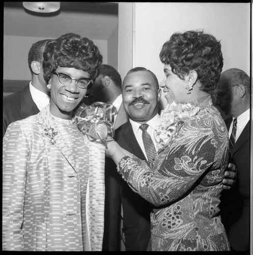 Woman pinning a corsage on Shirley Chisholm, Los Angeles, 1970