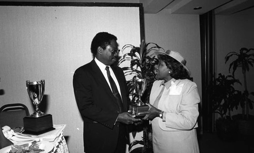 Dr. C. Z. Wilson receiving an award from Helen Rice Frederick during a luncheon, Los Angeles, 1986