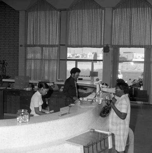 Tellers serving customers at Broadway Federal Savings Midtown Office, Los Angeles, 1974