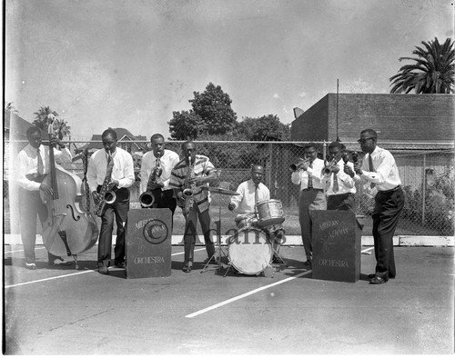 Milburn Newman Orchestra performing in a parking lot, Los Angeles, 1977