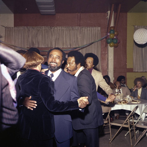 Herb Thompson talking among guests dancing together at his Super Bowl party, Los Angeles, 1977