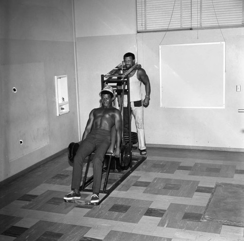 Men exercising at the Compton College gym, Compton, 1972