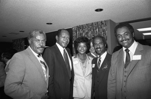 Tom Bradley, Donald Bohana and others pose for a group portrait at an event, Los Angeles, 1983