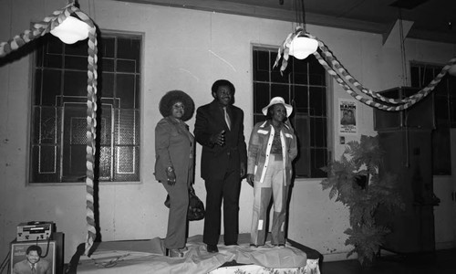 Hillard Hamm posing with two women on election night, Compton, 1975