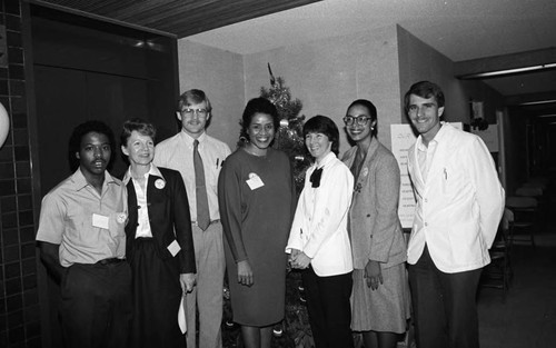 Dotson Medical Corporation staff posing together during a health care screening event, Los Angeles, 1984