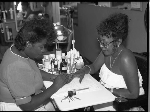 African American woman receiving a manicure, Los Angeles, 1984