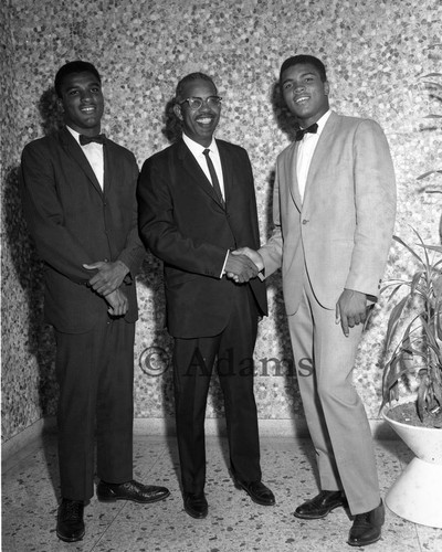 Muhammad Ali and Rahman Ali posing with Rev. F. Douglas Ferrell, Los Angeles, 1962