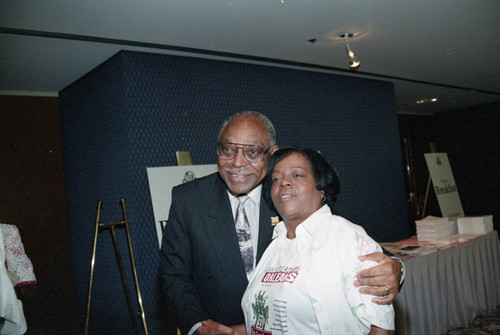 Rev. Cecil "Chip" Murray posing with a women at the National Newspaper Publishers Association convention, Los Angeles, 1993