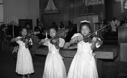 Young girls performing on the violin during a "Youth on Parade" event, Los Angeles, 1993