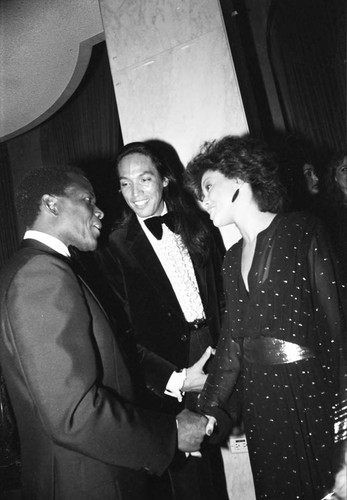 Sidney Poitier greeting Henry Singi and an unidentified woman at Neighbors of Watts benefit, Los Angeles, 1982