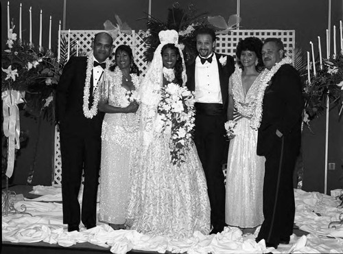 Mr. and Mrs. Andrews posing with members of their wedding party, Los Angeles, 1989