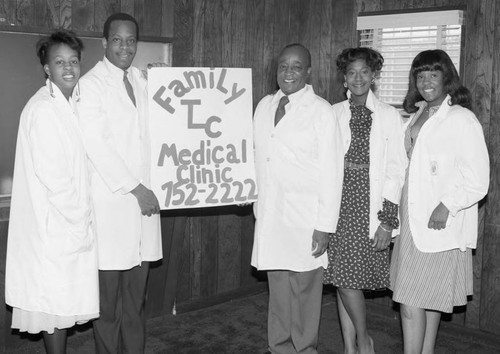 Dr. Gerald Nickerson, Sr. posing with family at the re-opening of the Family TLC Medical Clinic, Los Angeles, 1985